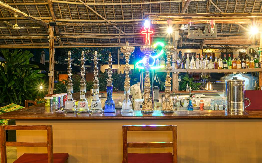 The beach bar lit up in the evening